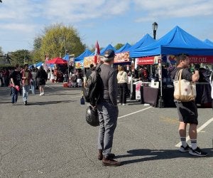 people walking around among festival tents